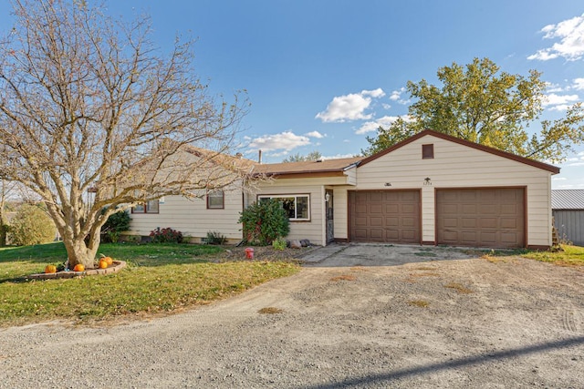 3234 14th Ave, Owatonna, MN 55060 - ranch-style house with a garage, asphalt driveway, and a front lawn