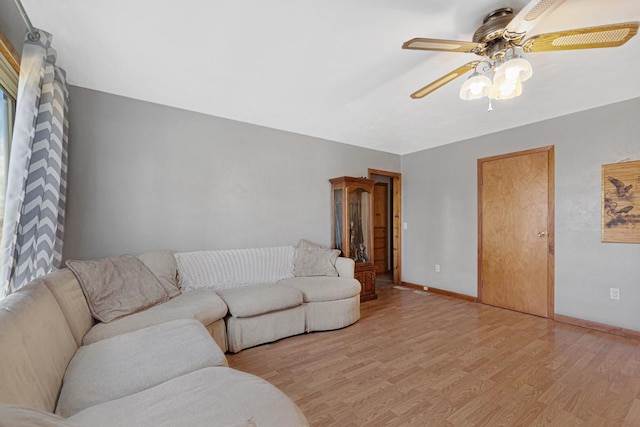3234 14th Ave, Owatonna, MN 55060 - living room featuring a ceiling fan, light wood-type flooring, and baseboards
