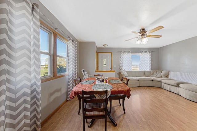 3234 14th Ave, Owatonna, MN 55060 - dining room featuring light wood finished floors, ceiling fan, and baseboards