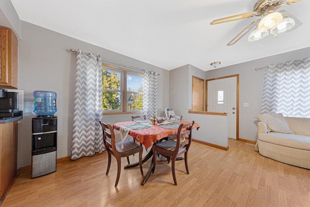 3234 14th Ave, Owatonna, MN 55060 - dining room featuring light wood-style flooring, baseboards, and a ceiling fan