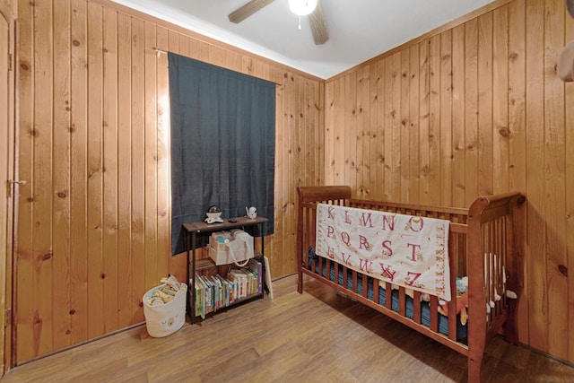 3234 14th Ave, Owatonna, MN 55060 - bedroom with wood walls, wood finished floors, and ceiling fan