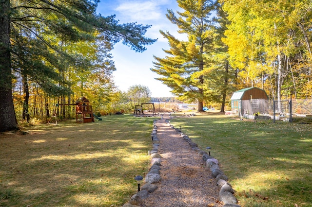 view of yard with playground community and fence