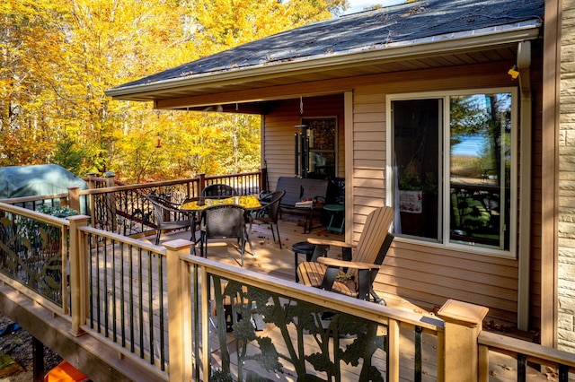 wooden terrace featuring outdoor dining space