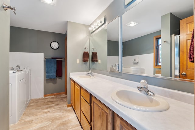 full bath featuring double vanity, a sink, and a bath