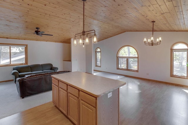 kitchen with light wood-type flooring, a wealth of natural light, a center island, and wood ceiling