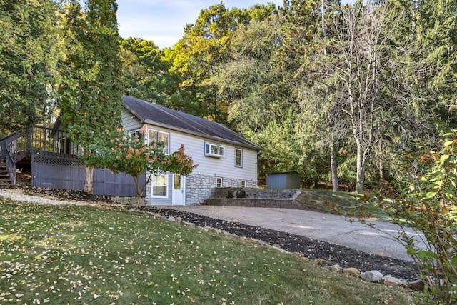 rear view of house with a patio and a lawn