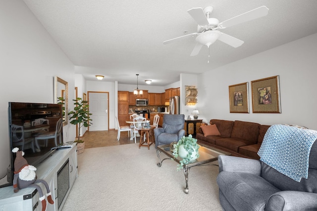 carpeted living room with a textured ceiling and ceiling fan