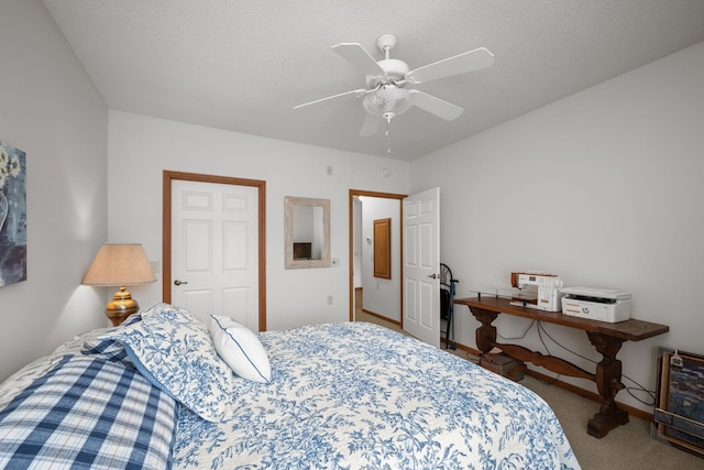 carpeted bedroom featuring a textured ceiling and ceiling fan