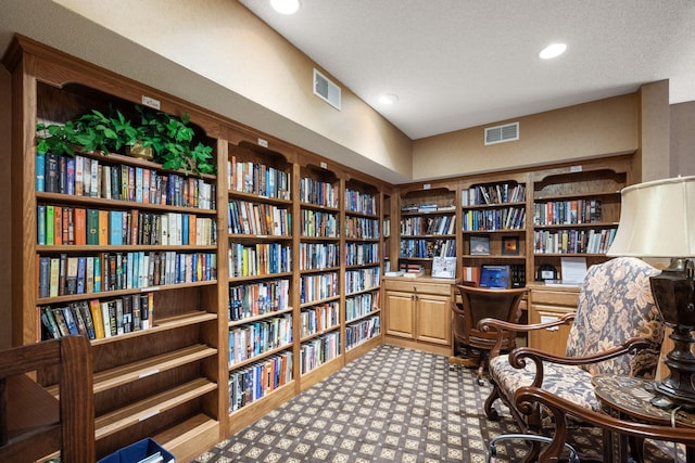 sitting room featuring a textured ceiling