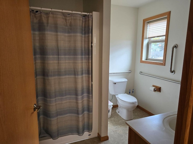 bathroom with vanity, toilet, a shower with curtain, and tile patterned flooring