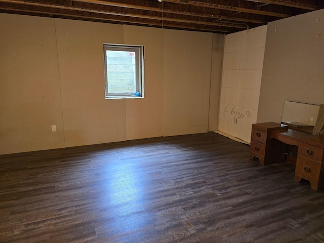 basement with dark hardwood / wood-style flooring