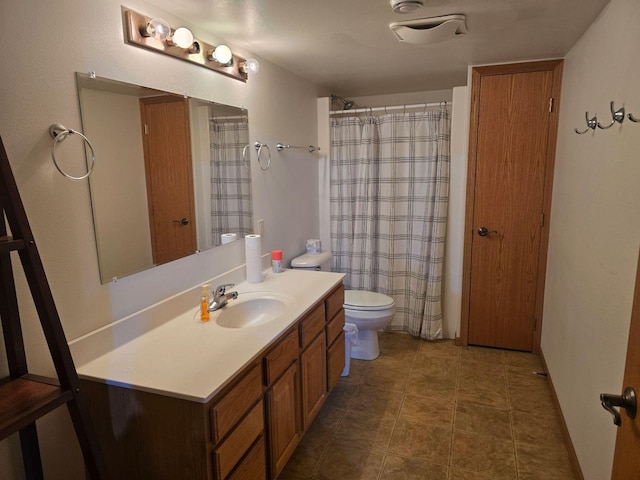 bathroom with vanity, toilet, and tile patterned flooring