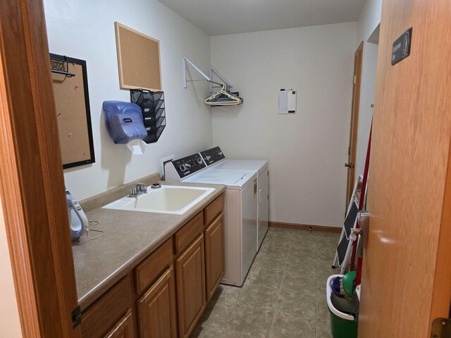 laundry room featuring sink, independent washer and dryer, and cabinets