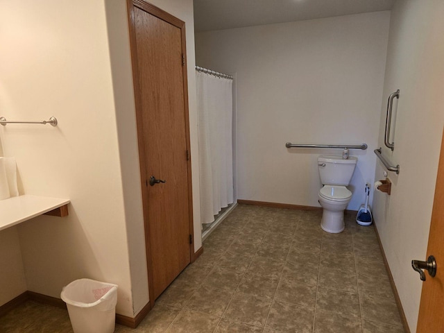 bathroom featuring toilet and walk in shower