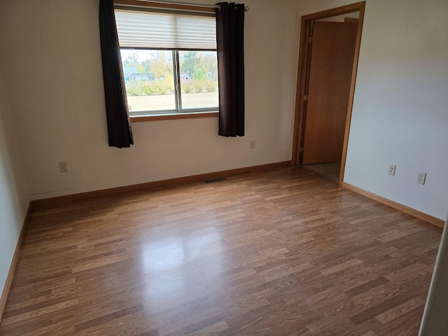 empty room with hardwood / wood-style floors