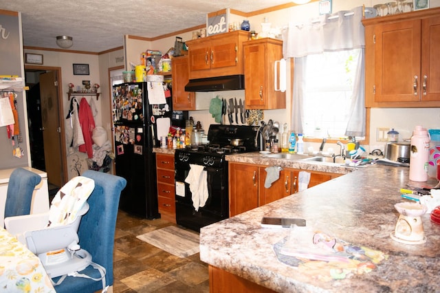 kitchen with black appliances, sink, a textured ceiling, ornamental molding, and exhaust hood