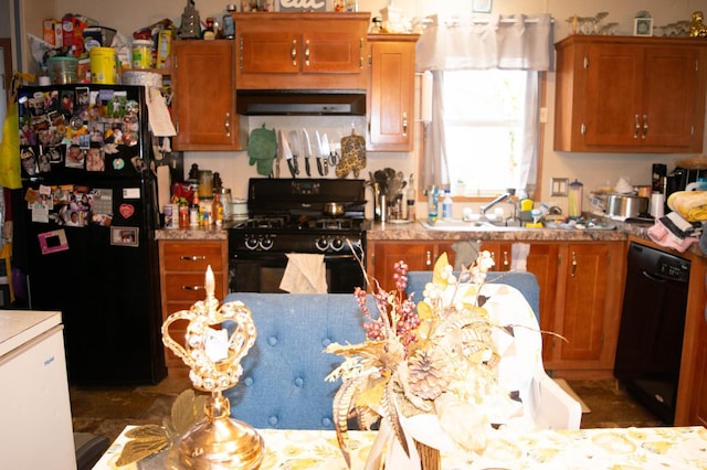 kitchen with sink, black appliances, and range hood