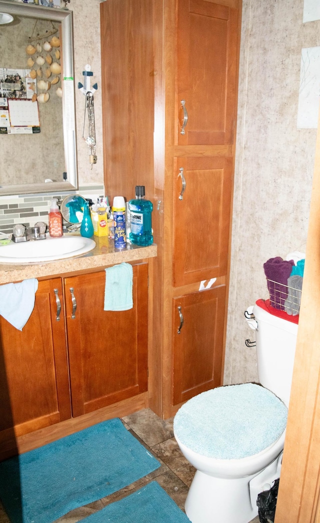 bathroom featuring vanity and toilet