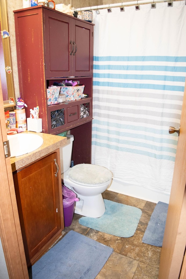 bathroom with vanity, toilet, and walk in shower