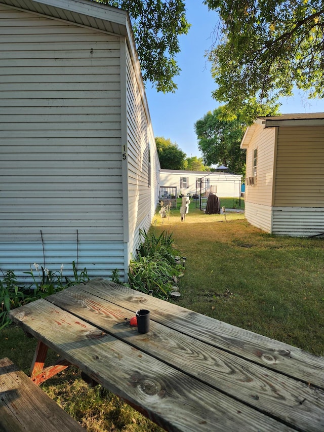 wooden terrace featuring a lawn