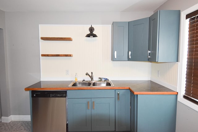 kitchen featuring dishwasher, blue cabinets, and sink