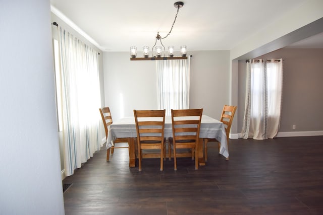 dining space with a notable chandelier and dark wood-type flooring