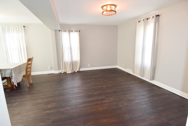 interior space with dark hardwood / wood-style floors and a wealth of natural light