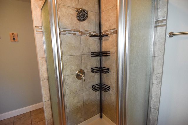 bathroom with tile patterned floors and a tile shower