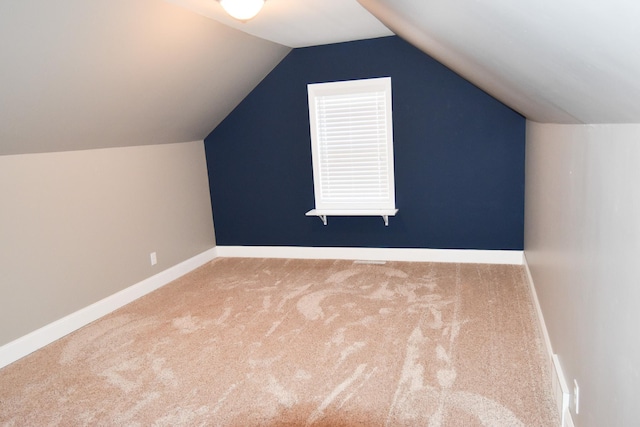 bonus room featuring carpet and vaulted ceiling