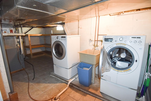 washroom featuring washing machine and dryer and tile patterned flooring