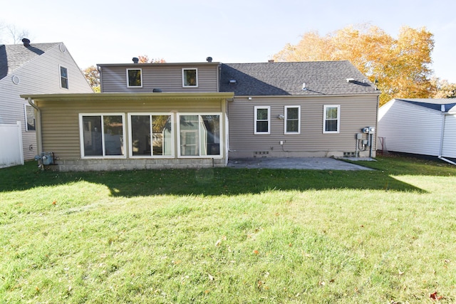 back of house featuring a patio and a lawn