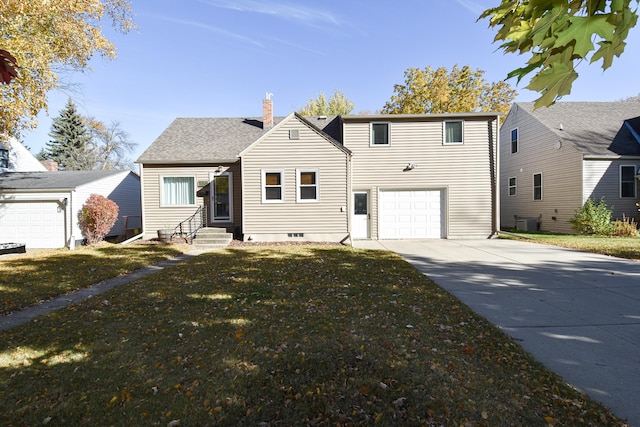 view of front of house featuring a front yard, a garage, and central AC unit