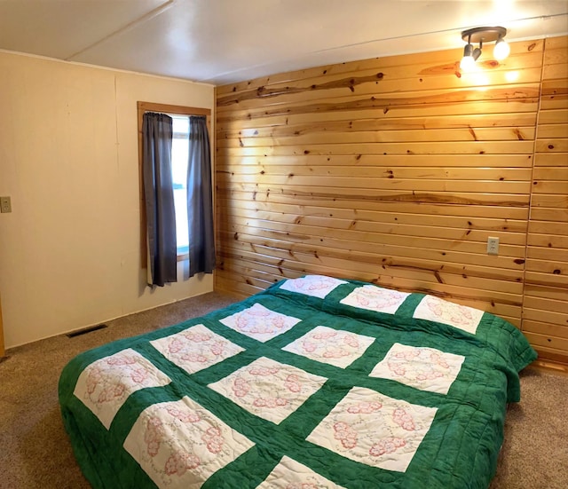 unfurnished bedroom featuring carpet flooring and wooden walls