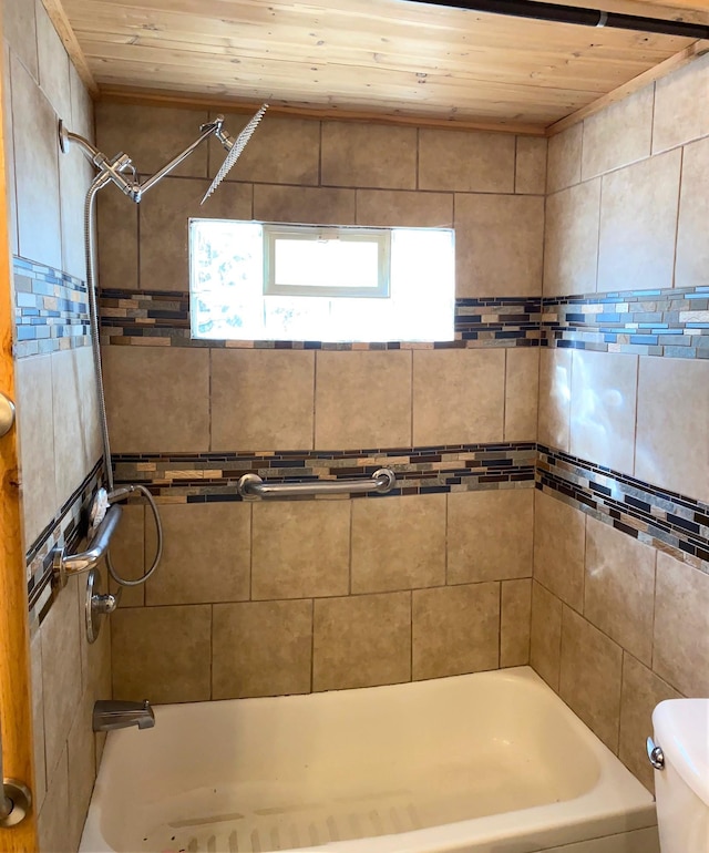 bathroom featuring tiled shower / bath combo, toilet, and wooden ceiling