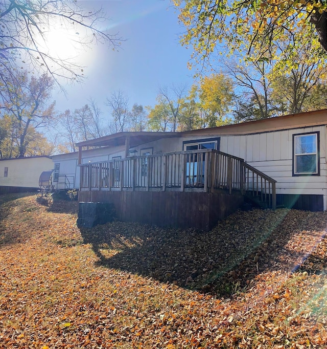 back of property with a wooden deck