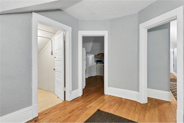 corridor with light wood-type flooring