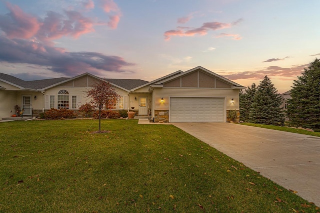 single story home with a garage and a lawn