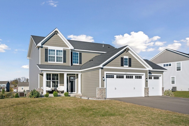 craftsman inspired home featuring a garage, a front lawn, central air condition unit, and a porch