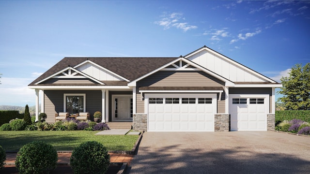 craftsman-style house featuring a garage, a front yard, and a porch