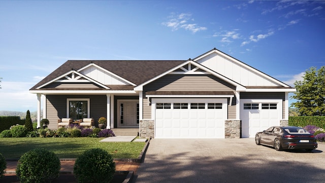 craftsman inspired home featuring a garage, covered porch, and a front lawn