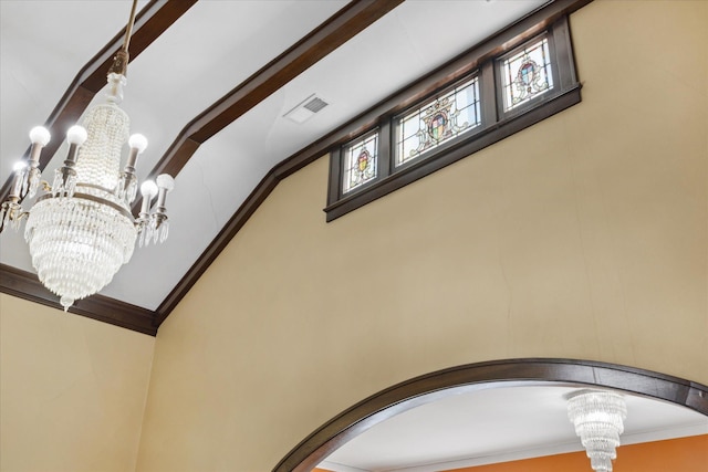 details with ornamental molding and a chandelier