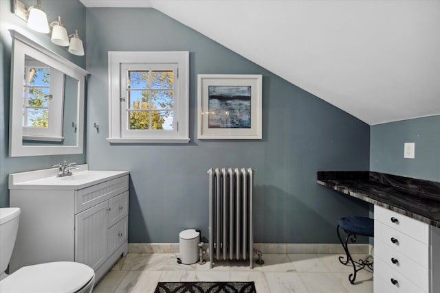 bathroom with toilet, lofted ceiling, vanity, and radiator