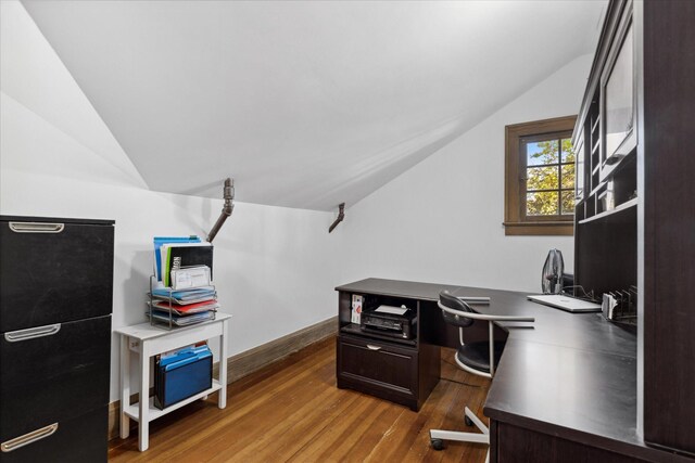 home office featuring lofted ceiling and dark hardwood / wood-style floors