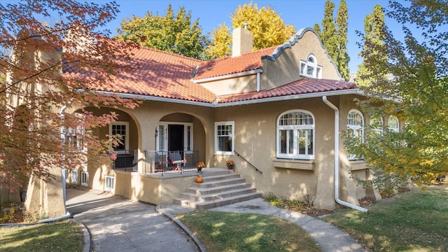 mediterranean / spanish home with a porch