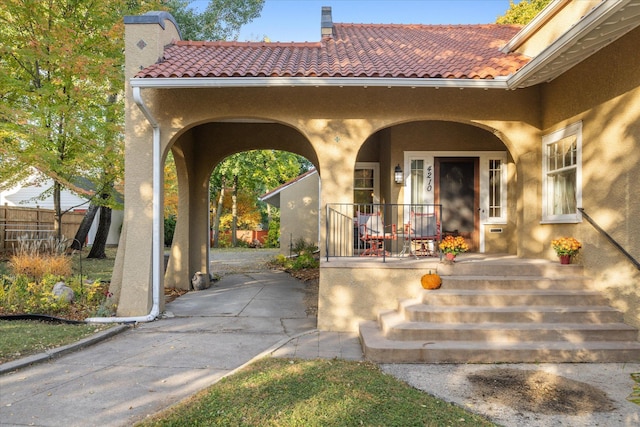 entrance to property featuring covered porch