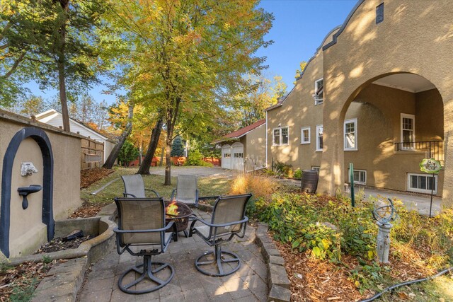 view of patio with an outdoor fire pit