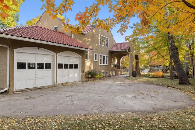 mediterranean / spanish house featuring a garage