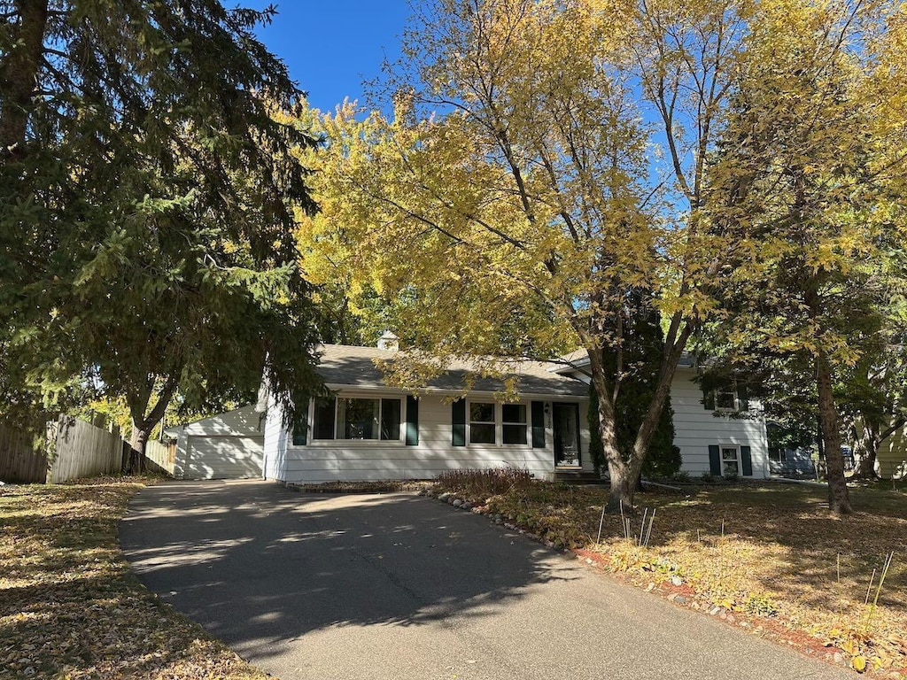 8784 Inman Ave S, Cottage Grove, MN 55016 - view of front facade with fence, a garage, and driveway