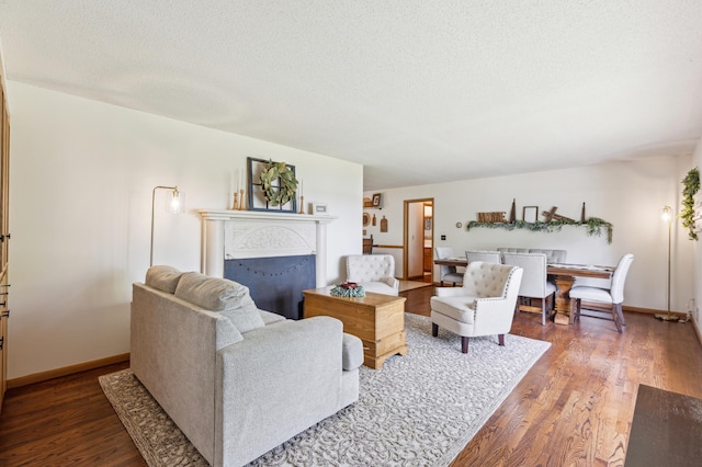 141 Lakeshore Dr, Big Lake, MN 55309 - living area with wood finished floors, baseboards, a textured ceiling, and a fireplace