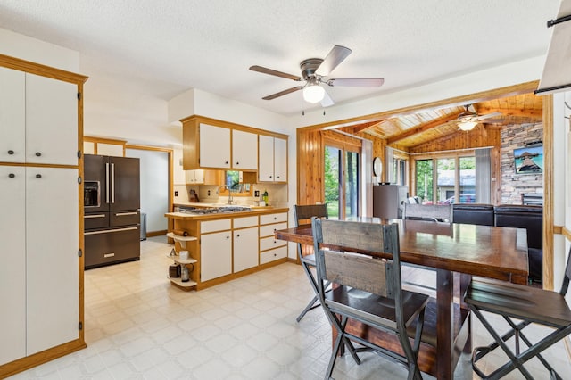 141 Lakeshore Dr, Big Lake, MN 55309 - dining space featuring ceiling fan, vaulted ceiling, light floors, baseboards, and a textured ceiling